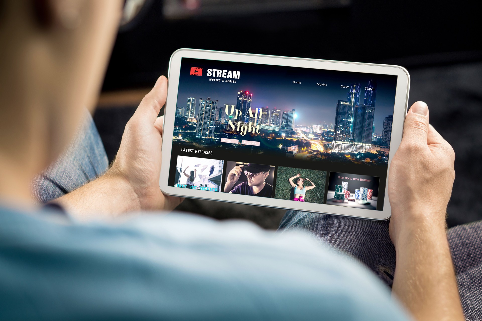 Movie and series stream VOD service in tablet. Watching on demand tv show or film online. Man choosing video entertainment from subscription media catalogue.
